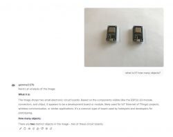 Two small electronic circuit boards on a white surface.