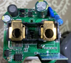 The image shows a close-up of a circuit board with various electronic components, including capacitors and resistors.