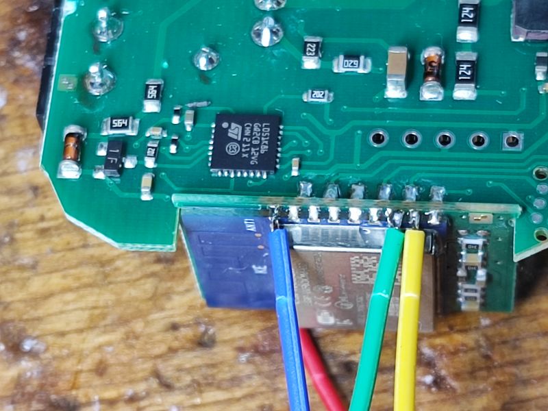 Circuit Board with Integrated Circuits and WiFi Module Close-up of a circuit board with integrated circuits and connected wires.