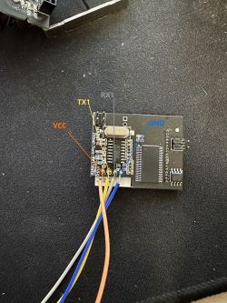Electronic module with labeled pins VCC, TX1, RX1, and GND.