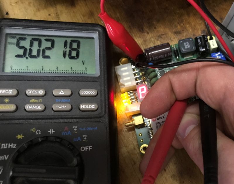Voltage measurement with multimeter on GPS module with LED display and active LEDs