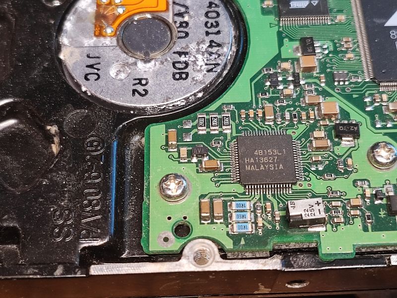 Inside an HDD with Visible Components Internal HDD electronics with visible components and moisture traces.