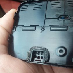 Image showing a plastic device casing with drilled holes.