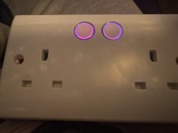 White power strip with two purplish backlit round buttons.