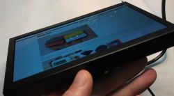 7 LCD EM713 monitor displaying a website at an angled side view