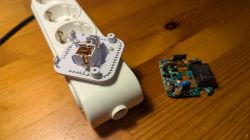 Disassembled power strip and electronics on wooden surface