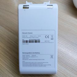 Dreame V9 Vacuum Cleaner Battery Dreame V9 vacuum cleaner battery on a wooden floor, showing technical details on the label.