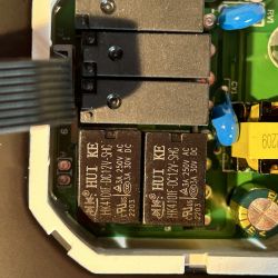 Inside of Thermostat with HUI KE Relays Close-up of the internal components of a thermostat with three HUI KE relays mounted on a circuit board.