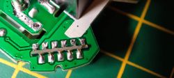 Interior of Smart Plug with PCB Components Close-up of the interior of a smart plug, showing PCB components and solder connections.