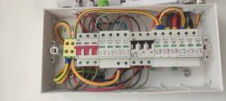 Interior of an electrical box with wiring and fuses.