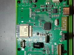 Close-up of a green PCB with a T1-U-HL module, an IC, and a micro-USB port