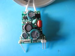 Small Printed Circuit Board with Electronic Components Close-up of a small printed circuit board with various electronic components on a blue background.
