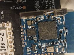 Electronic Module on Blue PCB Close-up of an electronic module with visible components on a blue PCB.
