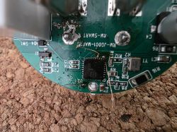 Close-up of a PCB with SMD parts, thin wires, and burn marks around solder joints