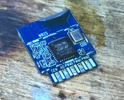WB2S Module with BK7231T Chip Image of a WB2S module with a BK7231T chip placed on a wooden surface.