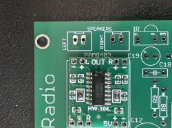 Close-up of a PCB with a PAM8403 module and labeled speaker and IR connector pads.