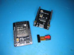 ESP32 modules and OV3660 camera on a blue background