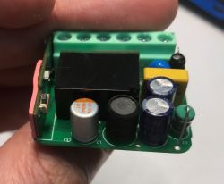 Close-up view of Sonoff MiniR4M relay internal components, including capacitors and inductor