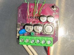 Circuit board with electronic components, including capacitors and a connector.