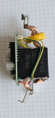 Electronic module with GPD-102 relay and copper wires on grid paper