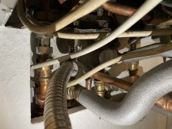 Close-up of pipes and cables in a heating system with Junkers boiler.
