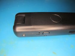 Black voice recorder with microphone and control buttons Close-up of black voice recorder with visible microphone and buttons.