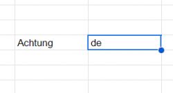 Google Sheets cell with the word Achtung and language code de