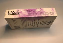 White NXT Gear 20,000 mAh power bank box with purple print and tech specs