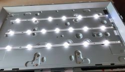 TV backlight panel with three rows of white LED strips turned on.