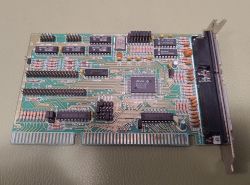 ISA I/O controller card with DB25 parallel port and ribbon connectors labeled IDE and FLOPPY