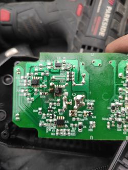 Damaged circuit board with a burnt component labeled Q3.