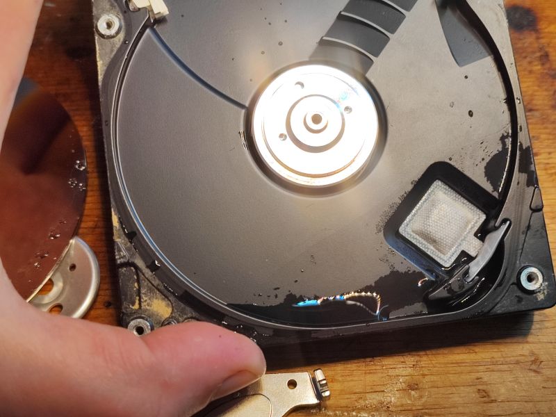 Flooded Hard Drive with Visible Moisture Interior of a flooded hard drive showing moisture.