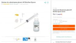 Printer Head Cleaning Kit Printer head cleaning kit with a bottle of fluid and a syringe.