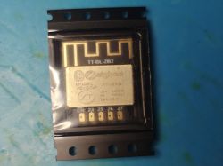Zigbee XT-ZB6 Bluetooth module in SMD carrier tape on a blue work mat