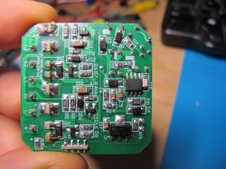 Image of an electronic module with components on a green printed circuit board.