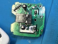 PCB board with power components and relay on a blue service mat