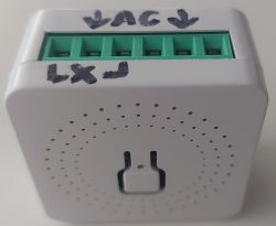 Front view of a white device case with green terminals and hand-written AC and Lx labels.