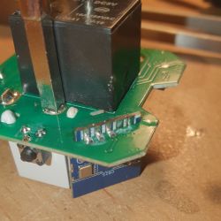 Close-up of a circuit board with an attached relay and soldering on CB2S contacts.