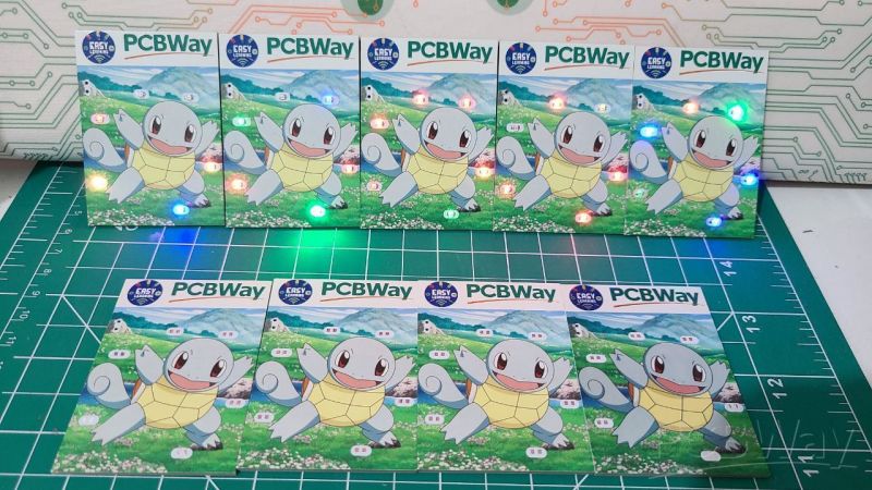 Several PCB boards with a cartoon character theme, arranged on a green cutting mat, featuring the PCBWay logo.