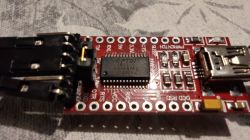 Red circuit board with FTDI chip and connectors.