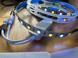 LED strip with RGB and white diodes connected to a controller.