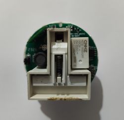 Round PCB with CNHZ relay and white spring-loaded mechanism on a white background