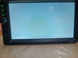 Car radio 7018B screen with a message asking to press the center of the plus sign.