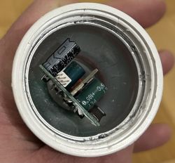 Interior of an opened LED bulb showing electronic components.