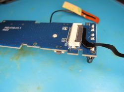 Printed circuit board with connected FFC ribbon cable Close-up of a blue PCB with a connected FFC ribbon cable