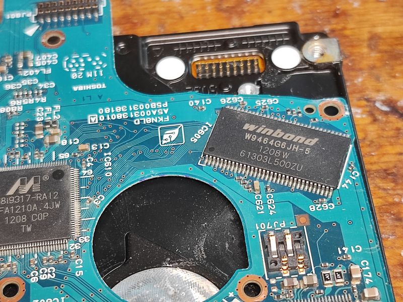 Toshiba Hard Drive PCB with Integrated Circuits Close-up of a Toshiba hard drive PCB with visible integrated circuits.