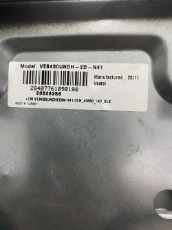 A label on the TV casing showing model VES430UNDH-2D-N41 and manufacturing details.