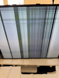 Broken TV screen with vertical lines.