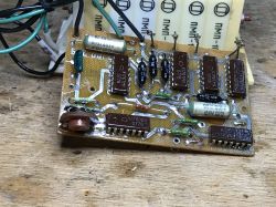 PCB with K176TM1 and K176NE5 ICs and wires on a wooden workbench