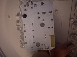 Close-up of the underside of a printed circuit board with solder points and traces visible.